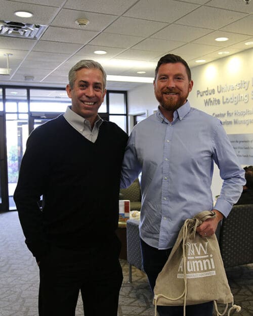 Scott Schaller poses with Brian Cheek in the lobby of the Hammond HTM Building
