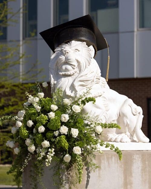 A lion sculpture in a graduation cap at Purdue University Northwest