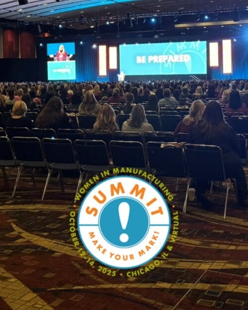 A conference room filled with people. The Women in Manufacturing Summit logo is at the bottom of the image.