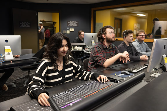 PNW students work at computers and switchboards in the Broadcast Center.
