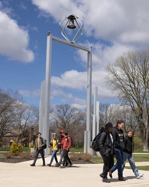 PNW students walk past the Bell Tower
