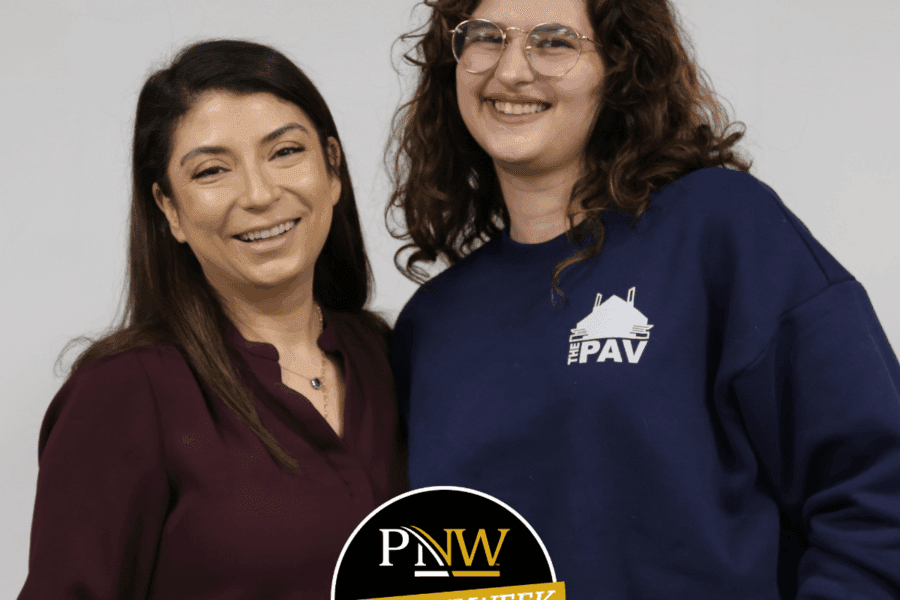 Two dark haired women smiling