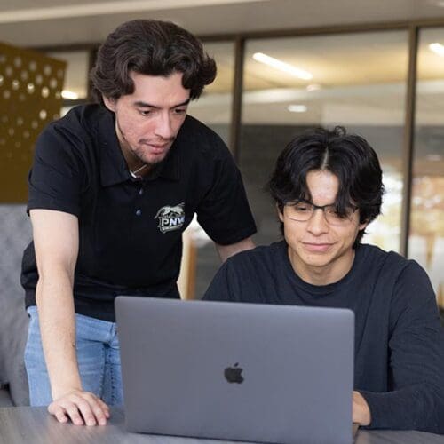 PNW students collaborate on a laptop