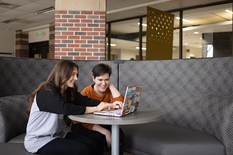 PNW students collaborate on a laptop