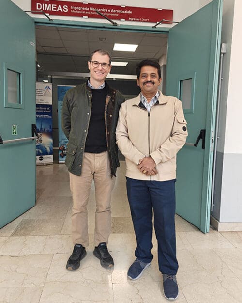 Alfonso Pagani and Magesh Chandramouli stand together in a doorway
