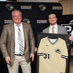 Former PNW pitcher Chad Patrick poses with his framed jersey at his jersey-retirement ceremony.