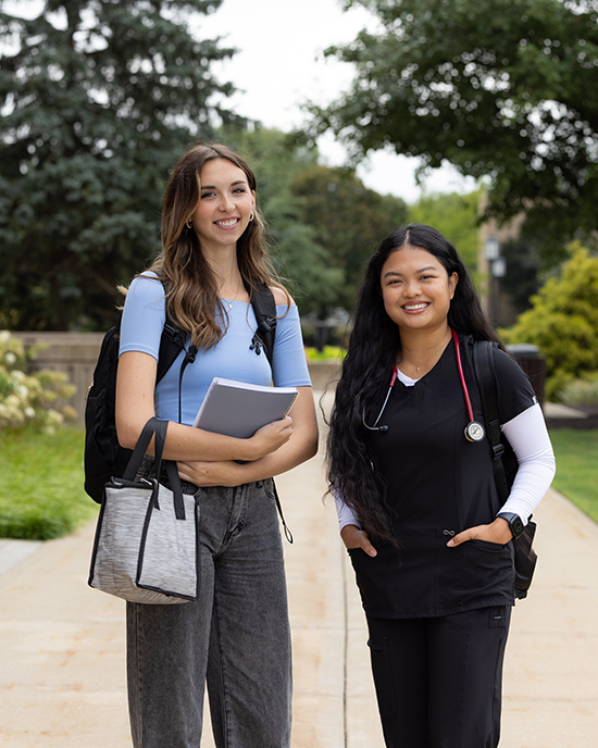 Two PNW students stand outdoors on the Westville Campus.