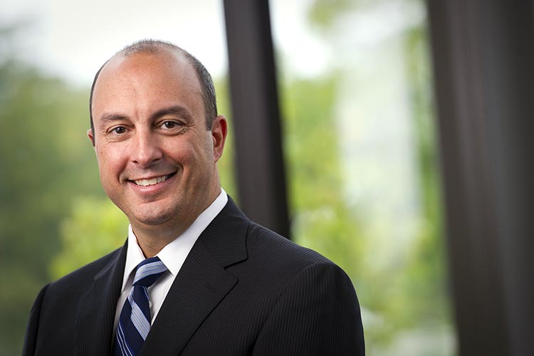 Deno Yiankes in suit and tie