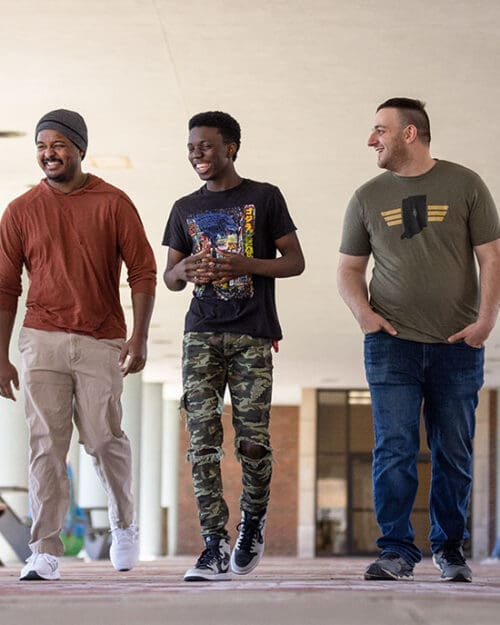 Three PNW Veteran students walk together outside the Classroom Office Building.