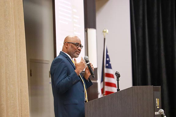 PNW professor Shontrai Irving speaks from a lectern.