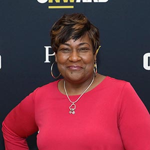 Kim Frazier before a PNW/Power Onward banner.