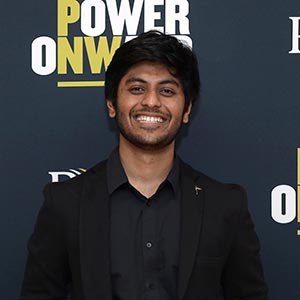 Naman Goyal before a PNW/Power Onward banner.