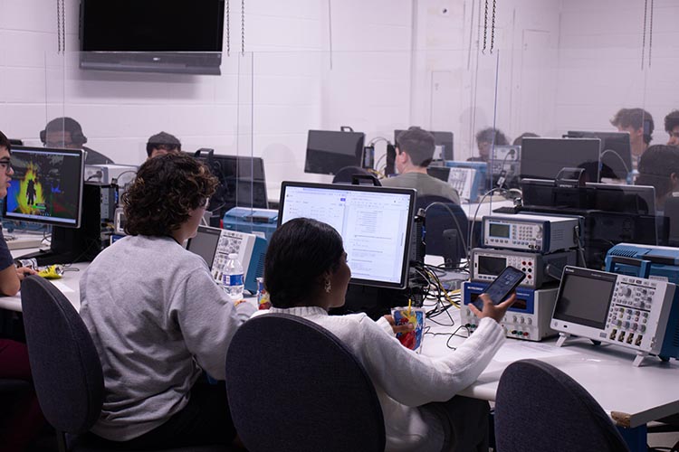 Students working on the computer at the PNW AI Camp