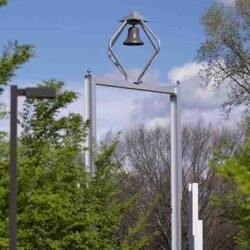 The PNW bell tower surrounded by green trees.