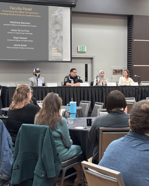 Four faculty panelists sit at a long table