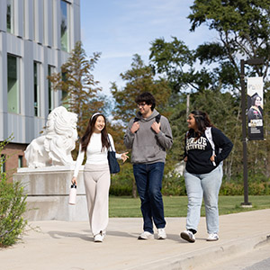 Three students walk outside of the Nils Building on the PNW Hammond Campus.
