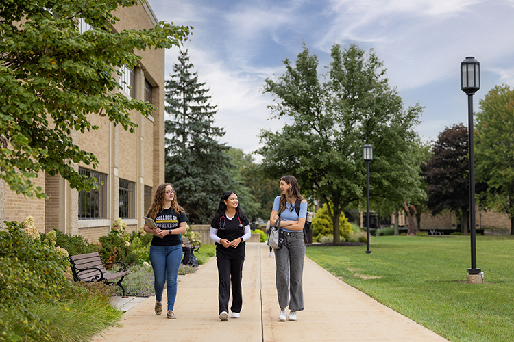 Three students walk together outside on the PNW Westville Campus