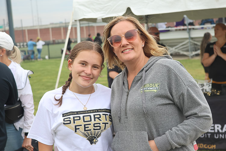 A parent and child pose together during the PNW sports fest.
