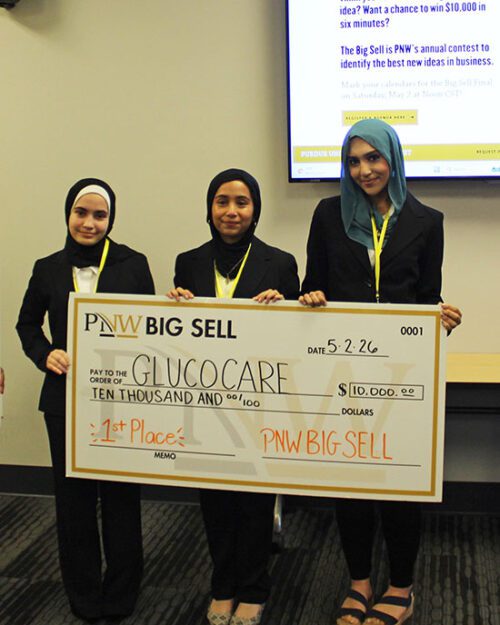 The Big Sell first place winner poses with a large check.
