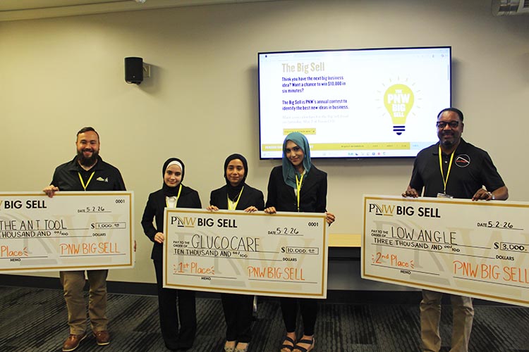 The top three 2026 Big Sell winners pose together holding large checks.