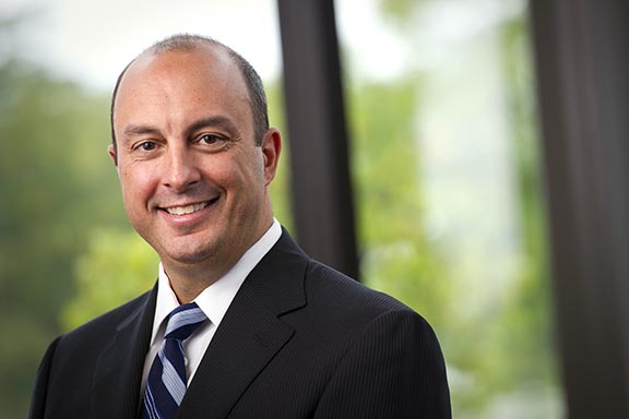 Professional photo of Deno Yiankes in a suit and tie