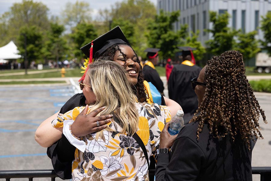A PNW graduate receives a hug