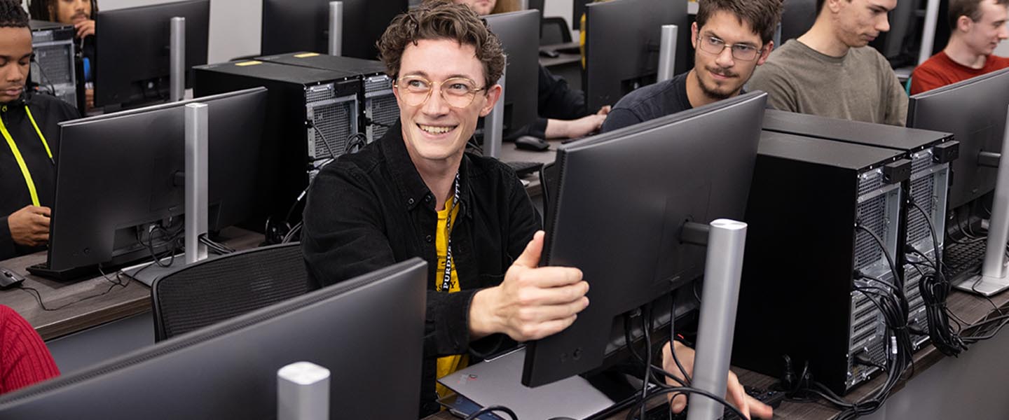 Room full of PNW students working on the computers in a computer lab 1440x600