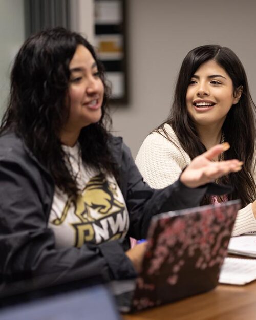 PNW students collaborate over a laptop