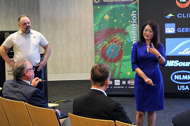 PNW professor Chenn Zhou presents research to Chancellor Holford and U.S. Representative Frank Mrvan in the PNW Center for Innovation through Visualization and Simulation