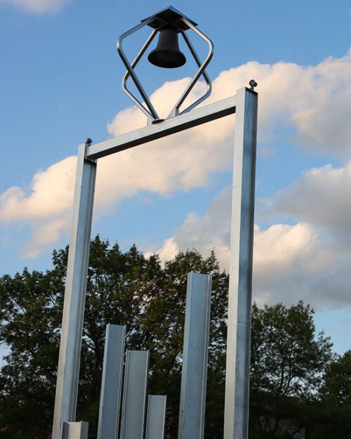 The PNW Bell tower pictured with clouds in the background.