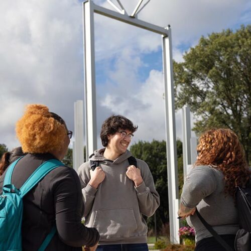 PNW students stand in front of the Bell Tower