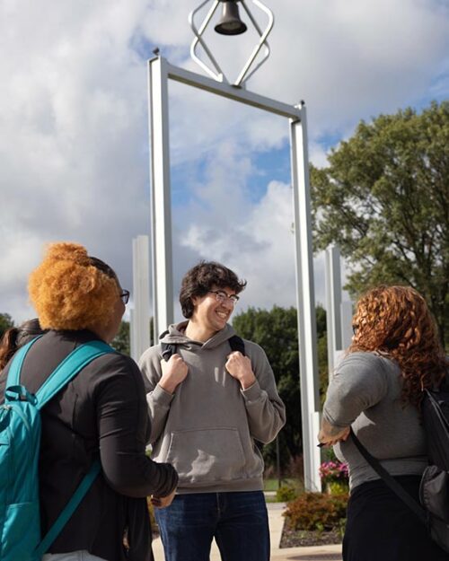 PNW students stand in front of the Bell Tower