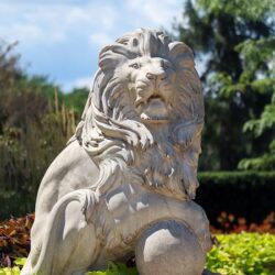 A lion sculpture outdoors amidst greenery at Purdue University Northwest.