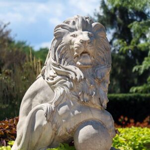 A lion sculpture outdoors amidst greenery at Purdue University Northwest.