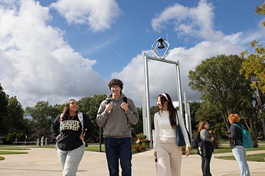 PNW students walk in front of the PNW Bell Tower