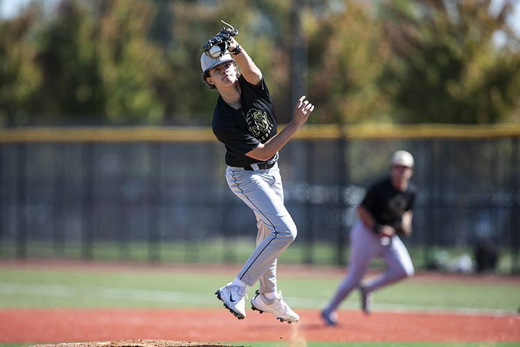 A PNW baseball pitcher releases a pitch.