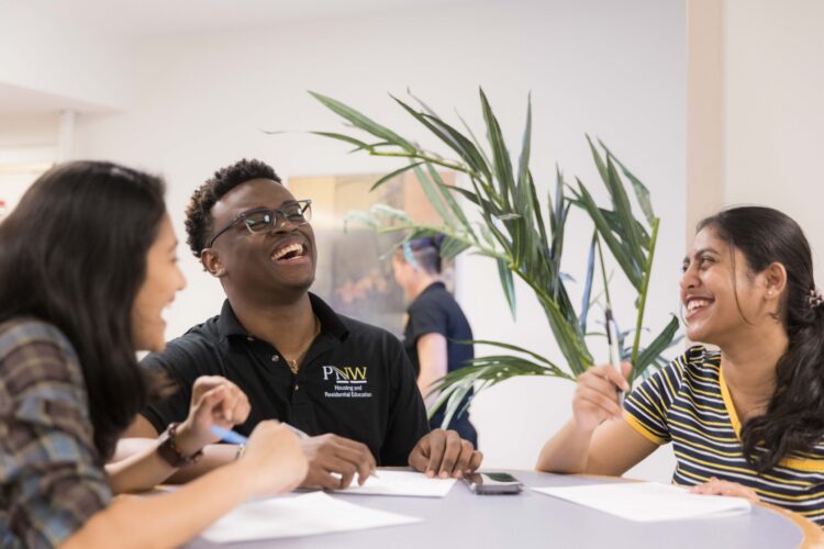 Three students sit together at a table